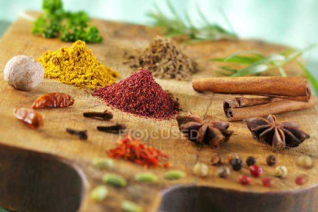 Closeup view of various spices on a wooden board — Stock Photo