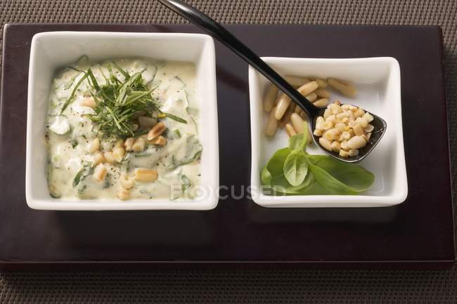 Elevated view of mayonnaise with basil and pine nuts — Stock Photo