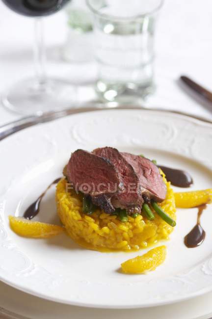 Beef steak on safron rice — Stock Photo