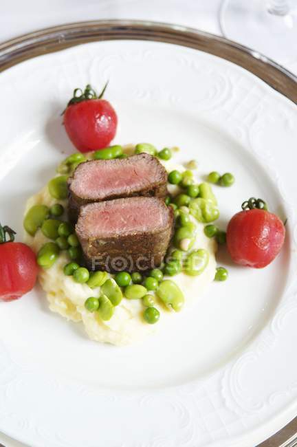 Roasted pieces of lamb with beans — Stock Photo