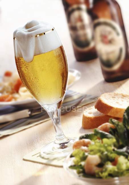 Salad and beer bottles — Stock Photo