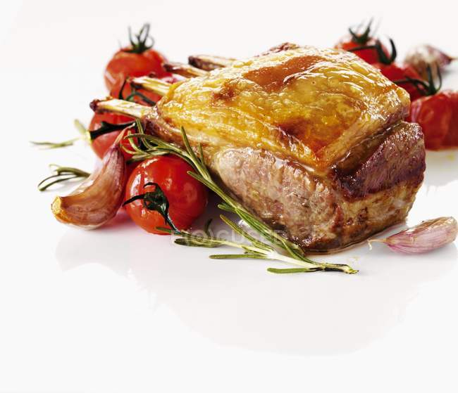 Roasted Rack of lamb with tomatoes and rosemary — Stock Photo