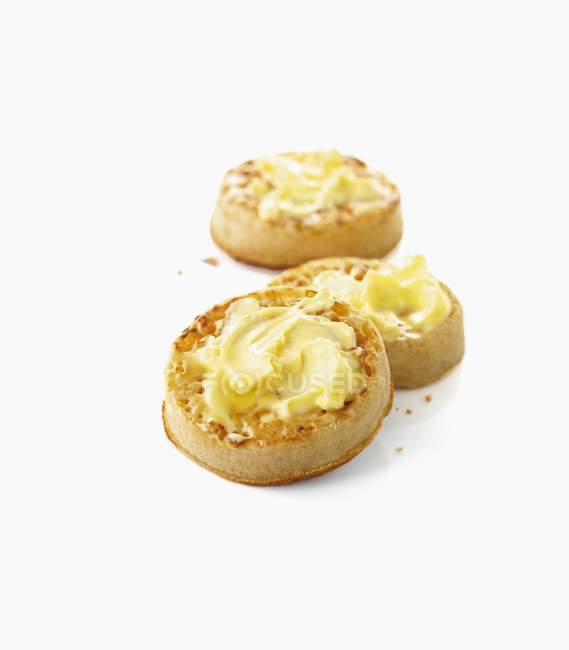 Closeup view of Crumpets with butter on white surface — Stock Photo