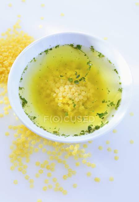 Star pasta soup with greenery — Stock Photo