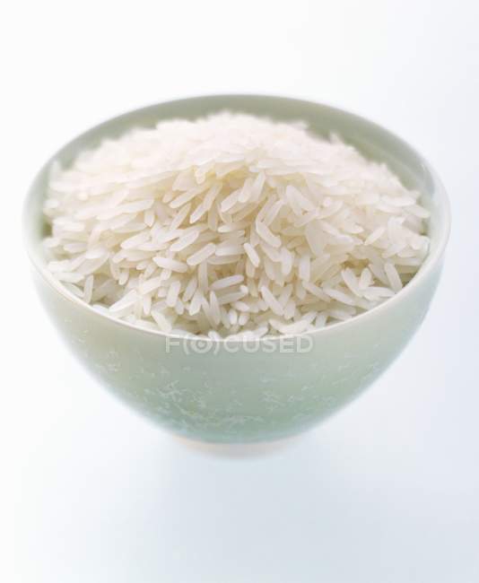Bowl of uncooked white rice — Stock Photo