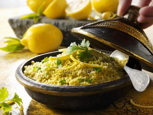 Couscous with lemons served in vintage wok — Stock Photo