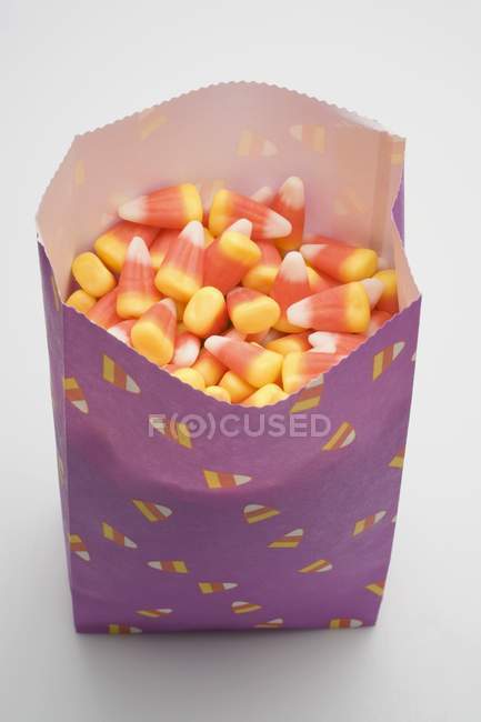 Candy corns in paper bag — Stock Photo