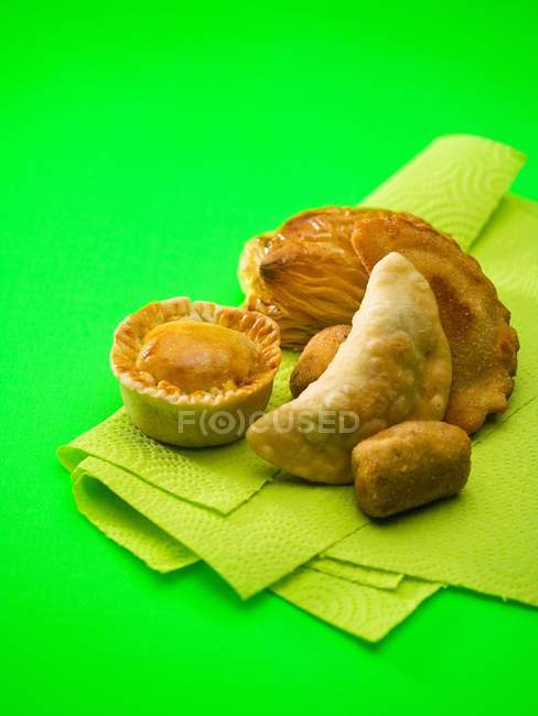 Elevated view of assorted pies and pastries on paper towel — Stock Photo