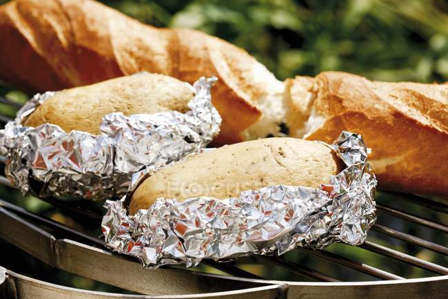 Baked potatoes and baguette — Stock Photo