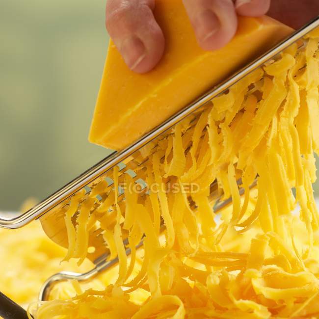 Grating Orange Cheese — Stock Photo