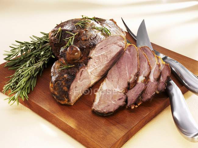 Partly carved Roasted leg of lamb — Stock Photo
