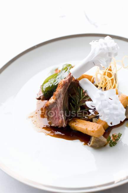Lamb chops with paper frills — Stock Photo