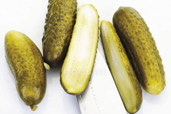 Whole and halved Pickled gherkins — Stock Photo