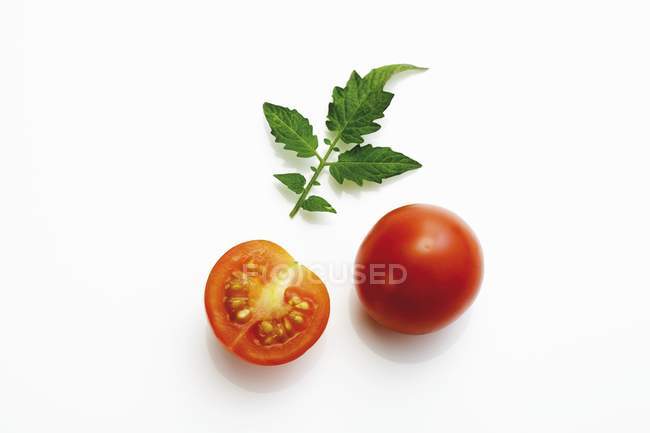 Whole and halved cocktail tomatoes — Stock Photo