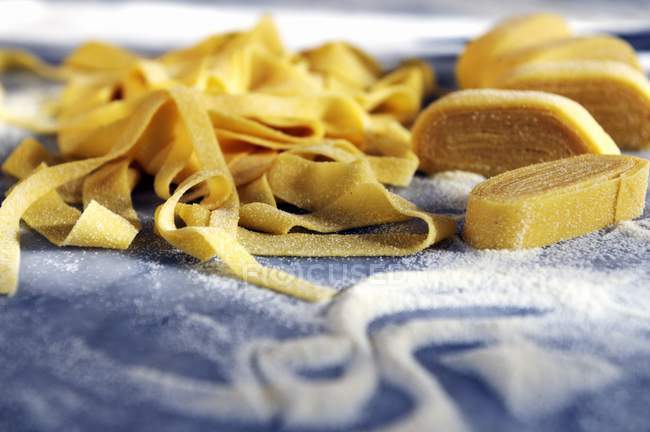 Raw tagliatelle pasta — Stock Photo
