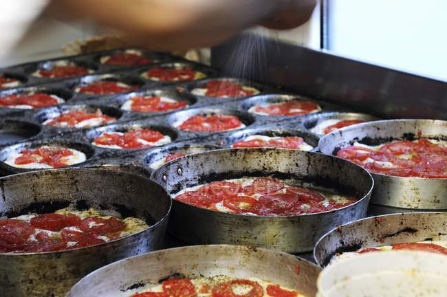 Unbaked tomato focaccia in baking tins — Stock Photo