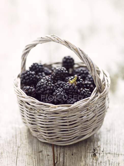 Blackberries in rustic basket — Stock Photo