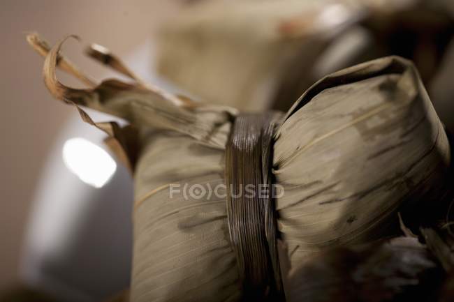 Closeup view of dumplings tied in leaf — Stock Photo