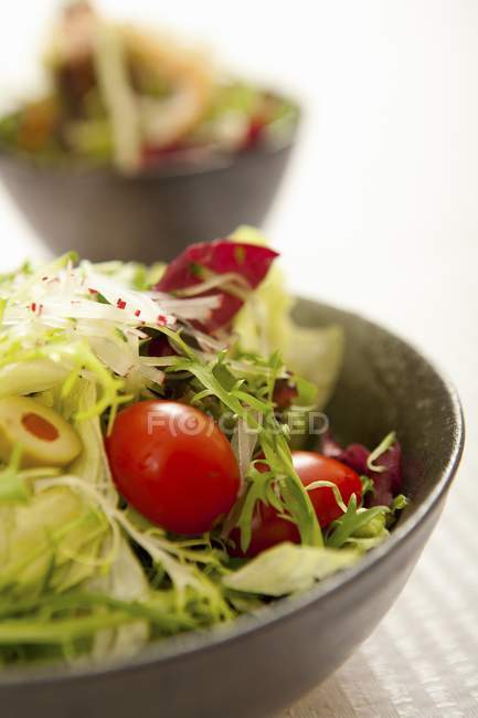 Mixed salad in black bowl — Stock Photo