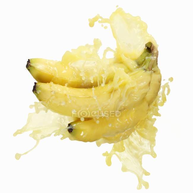 Bananas com suco salpicante — Fotografia de Stock