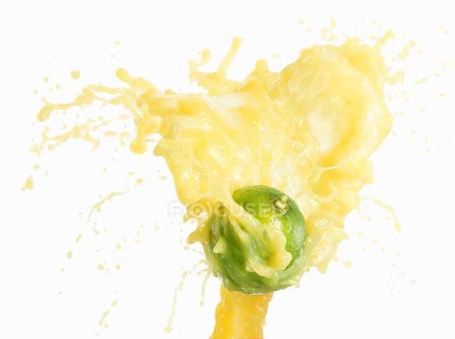 Chaux avec éclaboussures de jus de citron vert — Photo de stock
