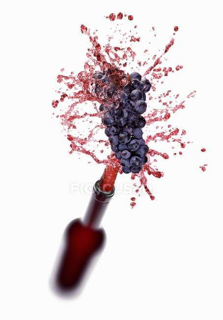 Vino rosso che schizza fuori dalla bottiglia — Foto stock
