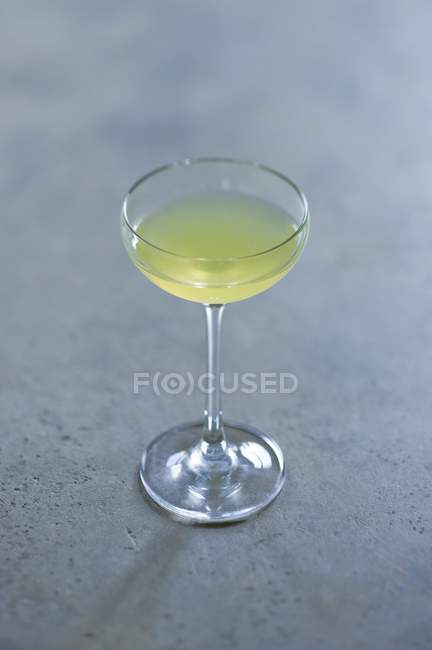 Closeup view of Limoncello in glass on gray surface — Stock Photo