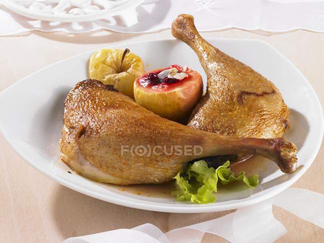 Goose legs with baked apple — Stock Photo
