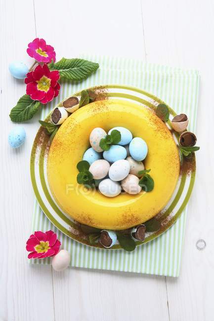 Vista superior de la crema moldeada de Zabaglione con azafrán, huevos dulces y flores - foto de stock