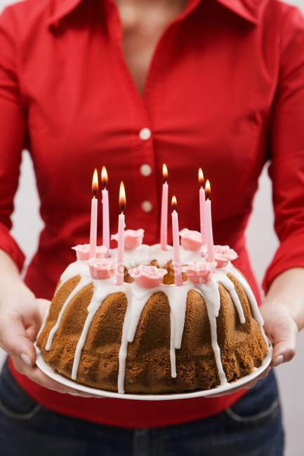 Woman holding iced ring cake — Stock Photo