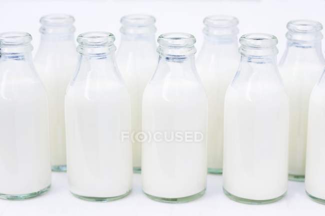 Closeup view of opened glass bottles of cream — Stock Photo