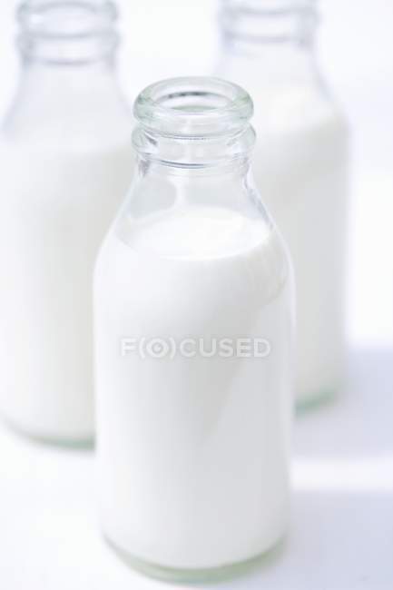 Closeup view of opened glass bottles of cream — Stock Photo