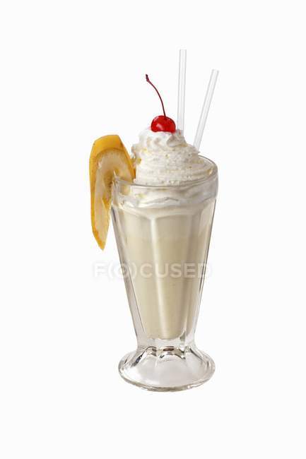 Banana shake with cream and cherry — Stock Photo