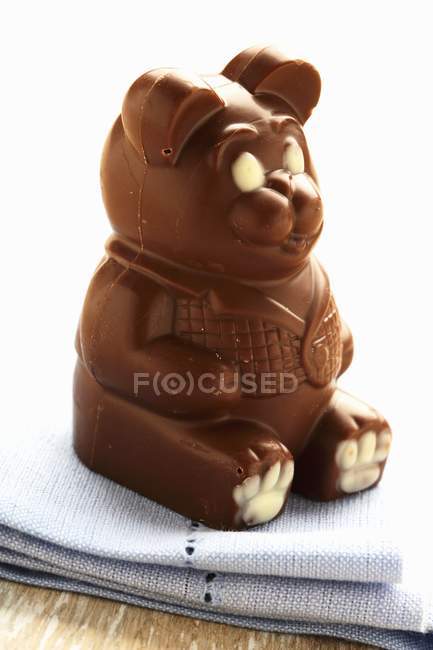 Chocolate bear on fabric napkin — Stock Photo