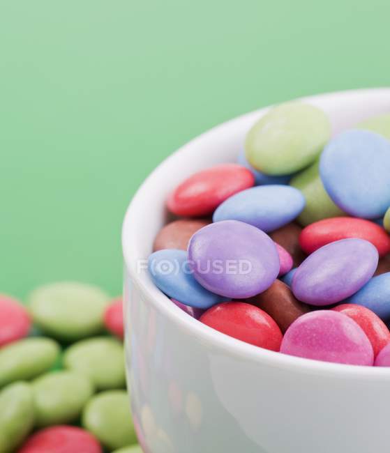 Closeup view of colored chocolate beans in bowl — Stock Photo