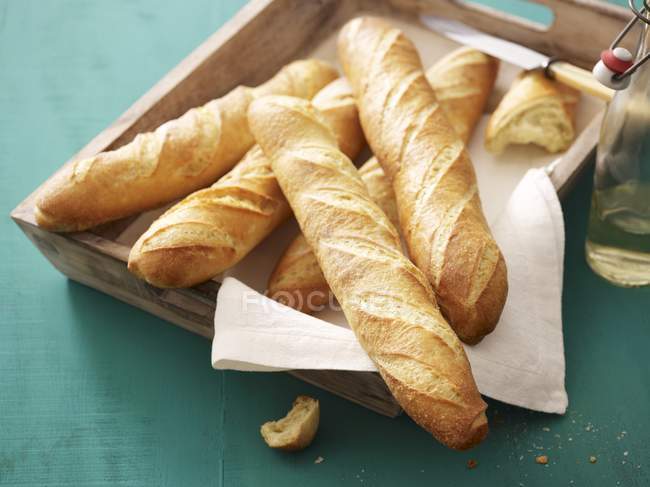 Baguettes on wooden tray — Stock Photo