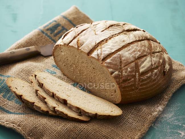 Loaf of bread on sack — Stock Photo