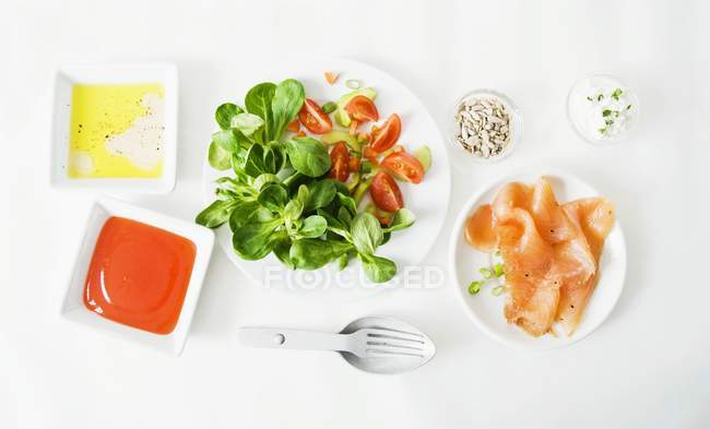 Various salad ingredients  on white surface — Stock Photo