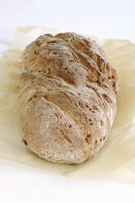 Walnut bread on paper — Stock Photo