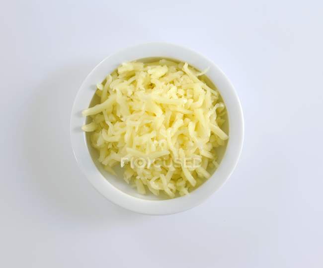 Dish of grated cheese — Stock Photo