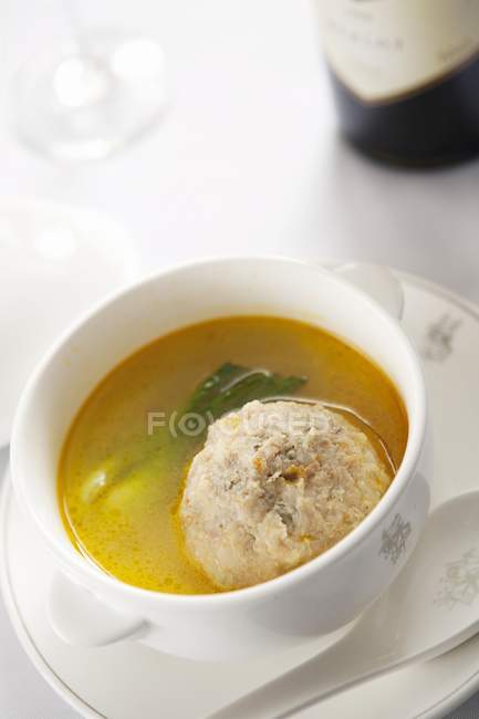 Closeup view of crab ball in soup with herb — Stock Photo