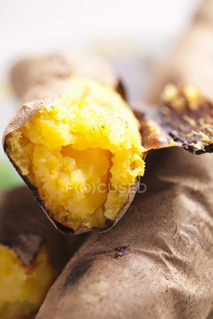 Roasted sweet potatoes on blurred background — Stock Photo