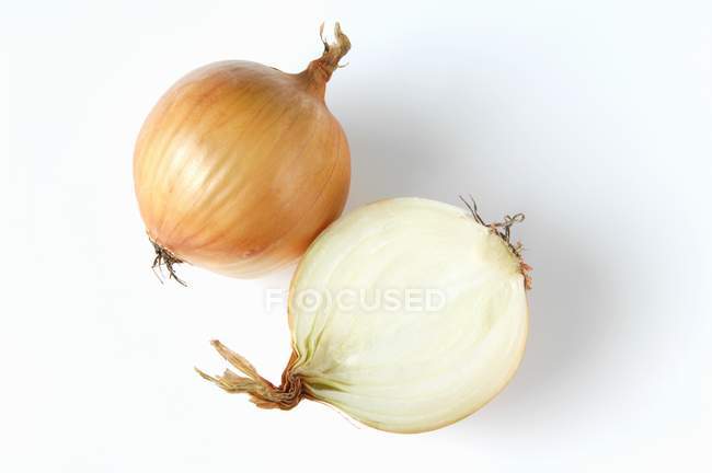 Whole and half an onion — Stock Photo