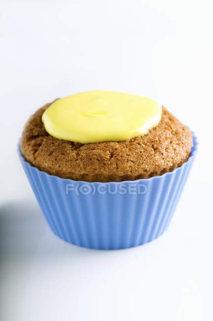Cupcake with yellow icing — Stock Photo
