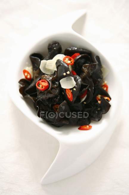Top view of fungus salad with chilli in white dish — Stock Photo