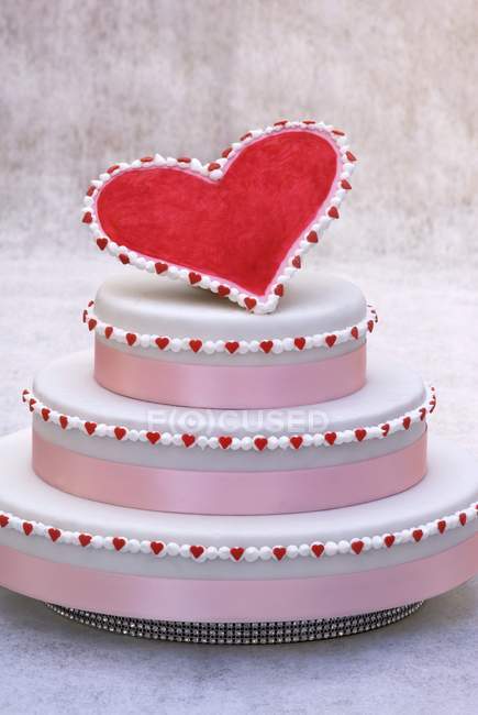Three tiered cake with red heart — Stock Photo