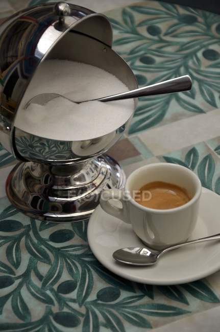 Cup of espresso and sugar pot — Stock Photo
