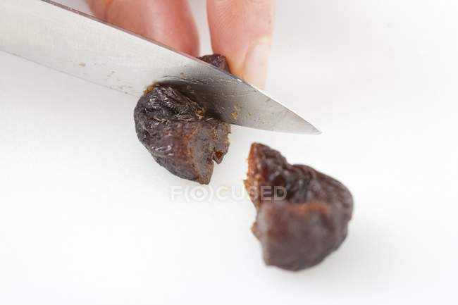 Closeup cropped view of person chopping prunes — Stock Photo