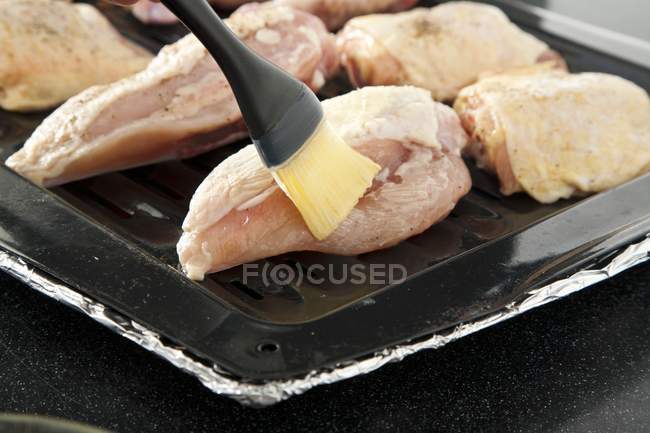 Brushing Chicken with Melted Butter — Stock Photo
