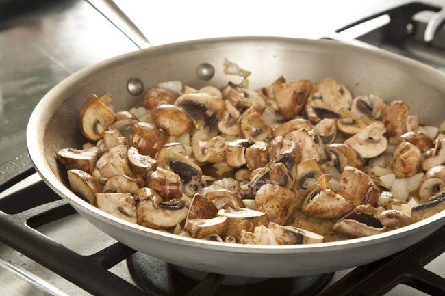 Mushrooms and Onions Cooking in a Skillet — Stock Photo